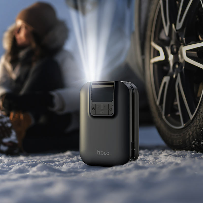 Hoco S53 portable smart air pump digital tire inflator with LED display and emergency light shown inflating a car tire in the UAE